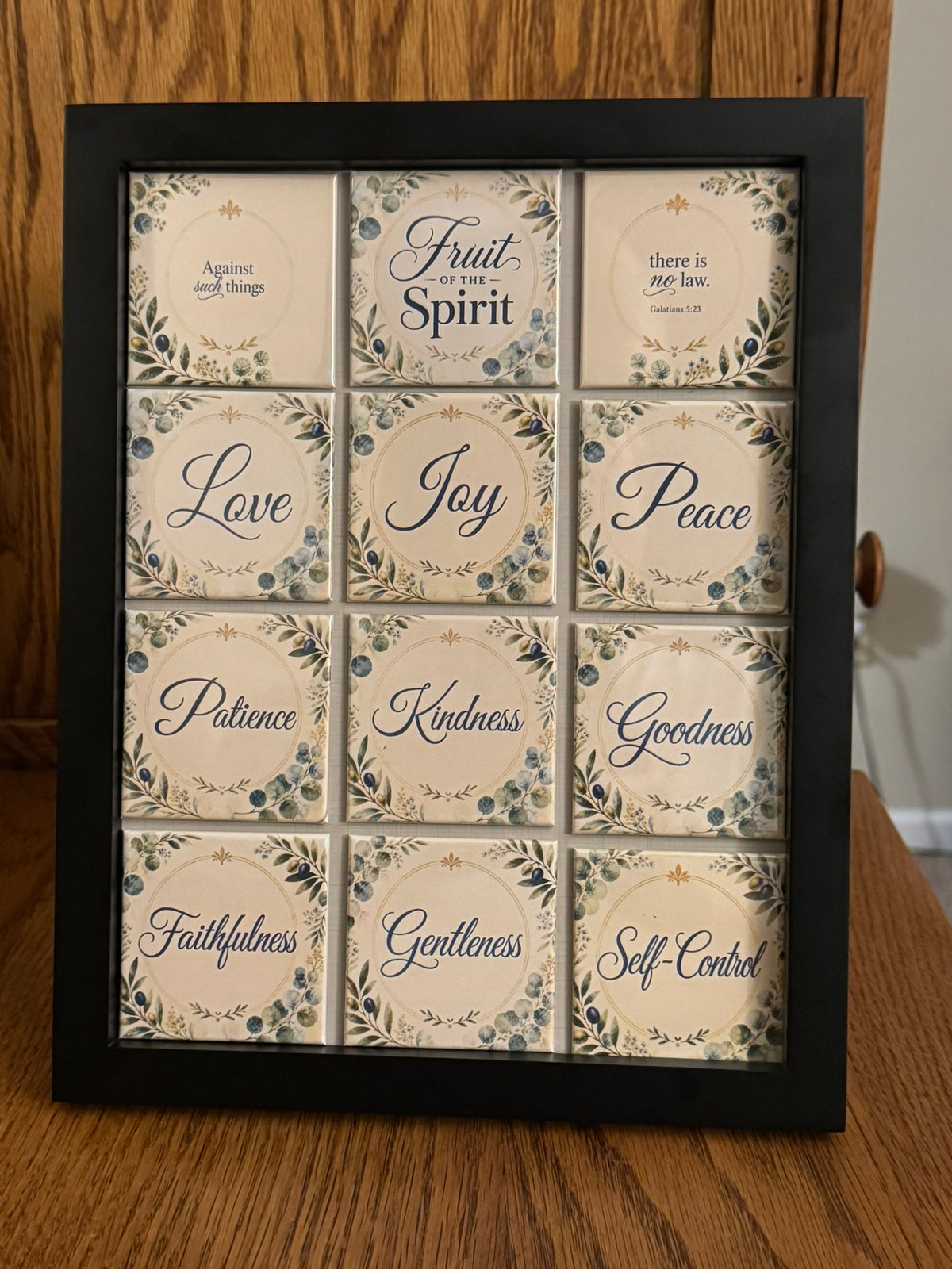 Fruit of the Spirit 12-piece magnet set in a black framed magnetic display featuring Galatians 5:22–23